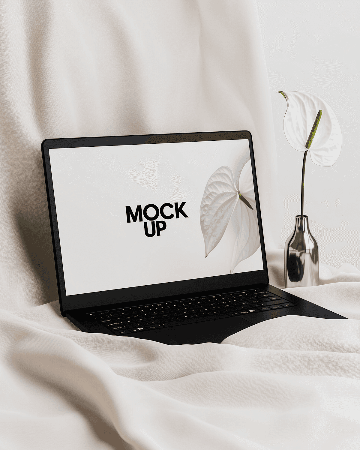 Laptop showing a studio website on cream fabric